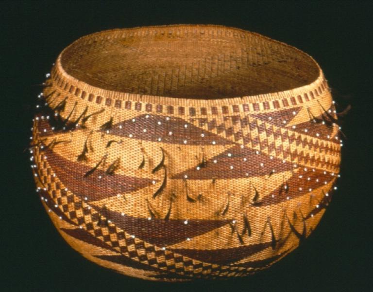 A pomo round beaded and feathered basket.